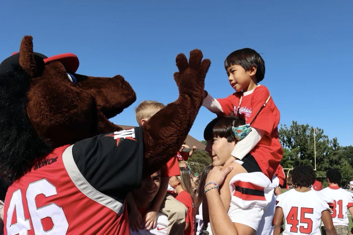 A kindergartner high fives Chidsey during the “Cookie Monster Cheer.” 