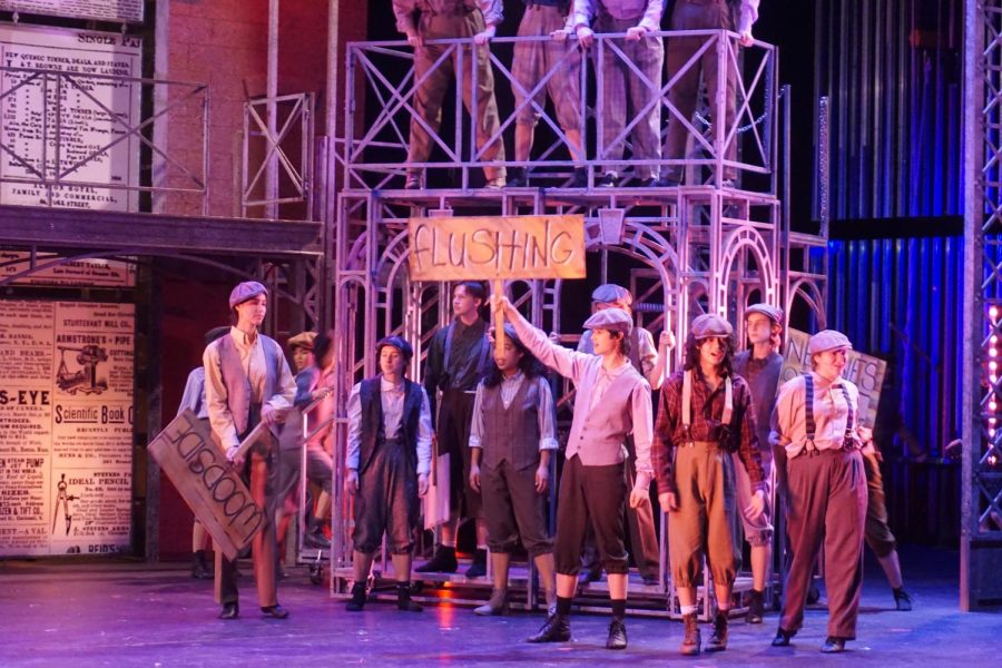 At a rally held by newsies in Medda Larkin’s theater, kids from different boroughs band together to fight for fair working conditions. 