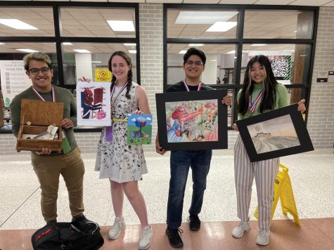 French students showcase their French-themed art. Left to right: Brandon Lozano holds his 3D project, Le Secret du Siècle des Lumières; Kacey Chapman displays her digital art entry as well as her acrylic painting; Isaí Melendez shows his color pencil work; Mia Hong displays her watercolor piece, La Reine des Céréales.