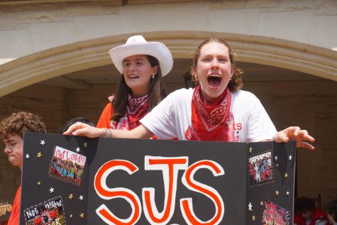 Seniors Frances Moriniere and Lily Price cheer for the SJS Spirit Club. 

