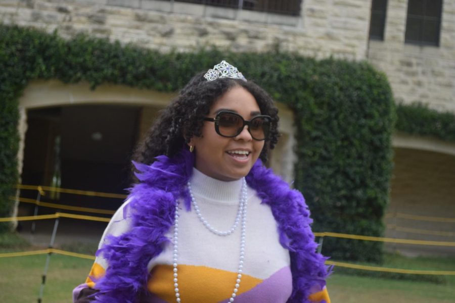 Senior Mia Harris wears a purple boa and a tiara for her Dress like Kinkaid outfit.
