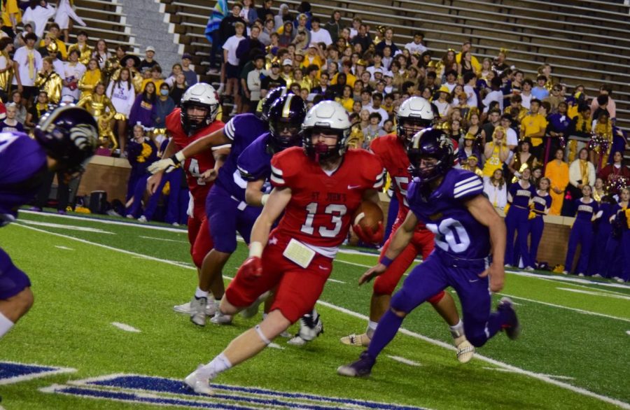 Senior running back Robert Riser evades the Falcons as he makes a dash for the end zone.