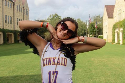 Senior Frances Moriniere shows off her Falcon glam, which features a black boa, colorful bracelets and a Kinkaid field hockey jersey. 