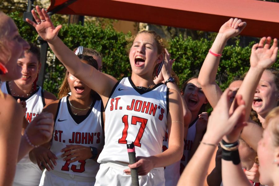 Sophomore Lexi Burger encourages her teammates, celebrating the end of a victorious season.