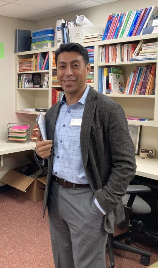 Upper School Spanish teacher Luis Gamboa poses for a photo right before meeting with his advisory.