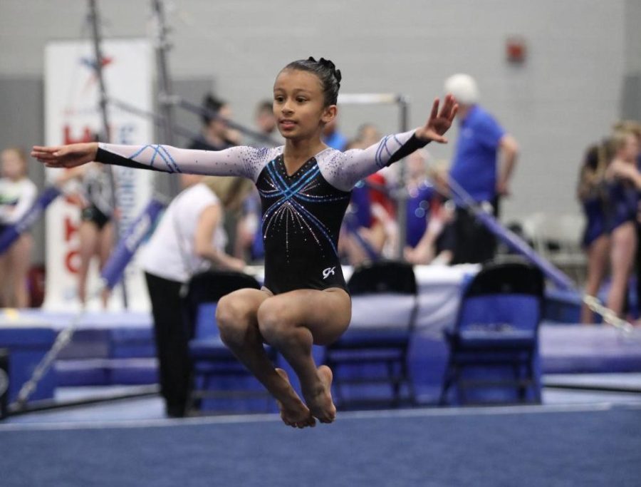 Ziya Ali leaps into the air to finish her routine.