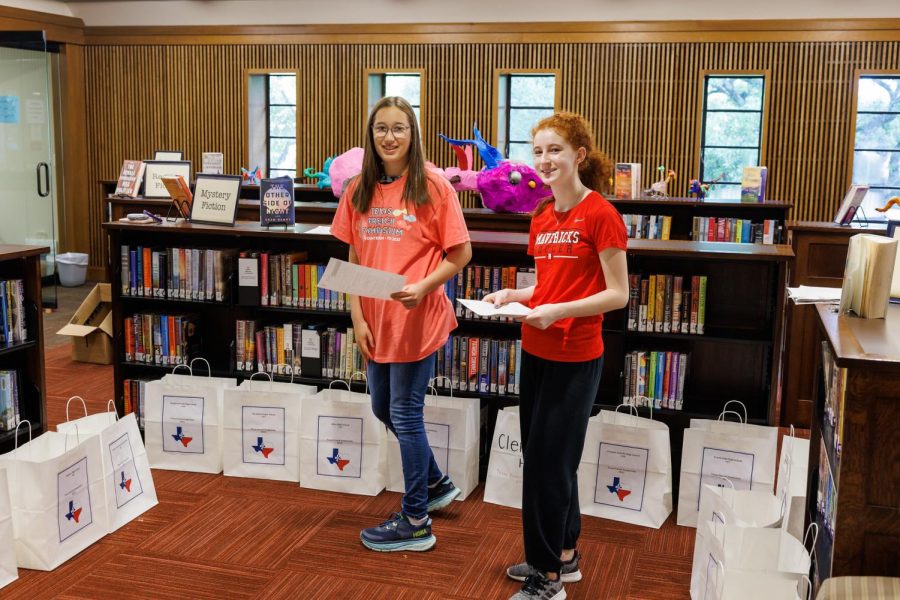 Freshman Kate Leibman and sophomore Aspen Toussaint prepare the Academic Commons for incoming competitors. 