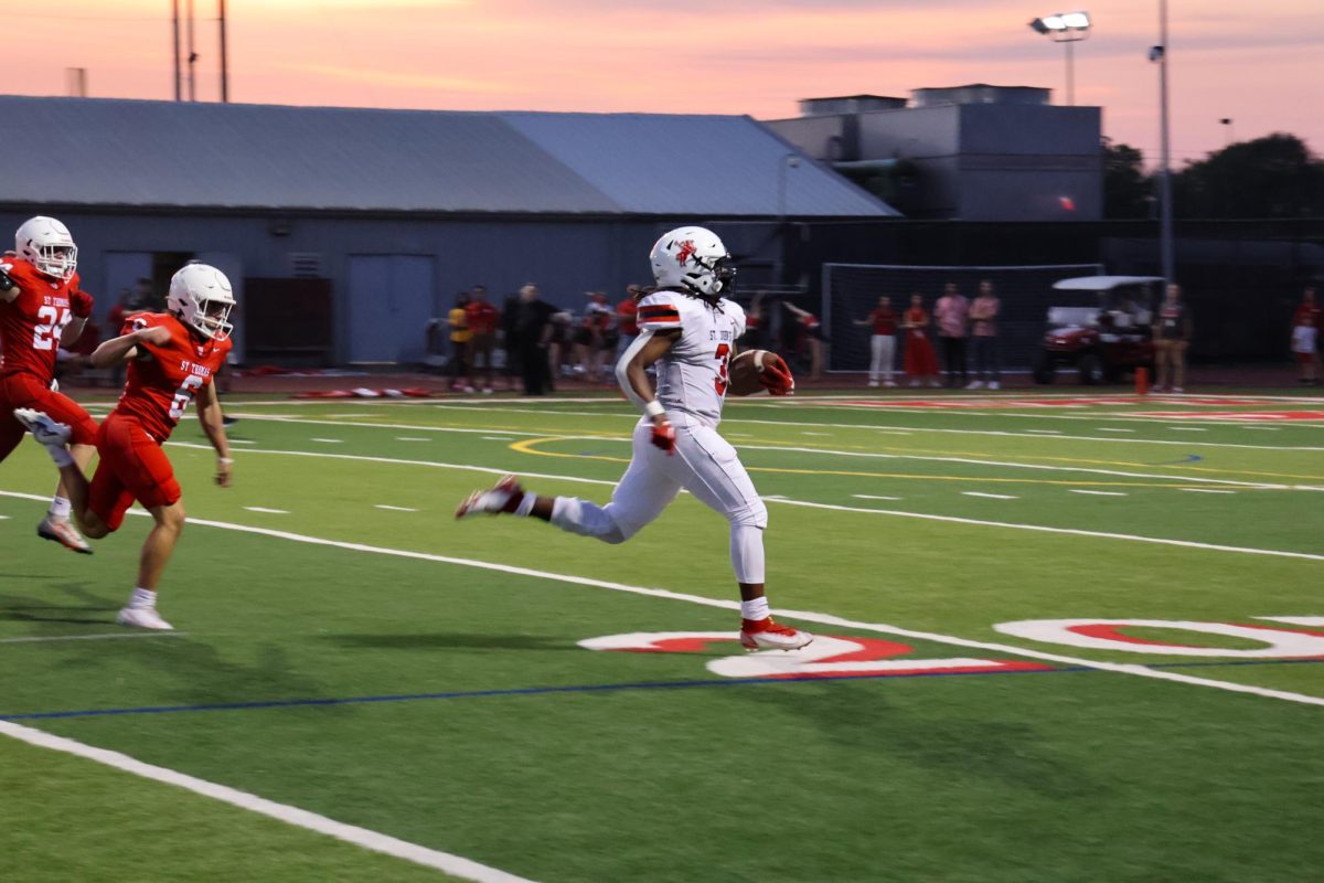 Quarterback Cole Allen slips through the St. Thomas defense line to even out the scoreboard moments before half time. 