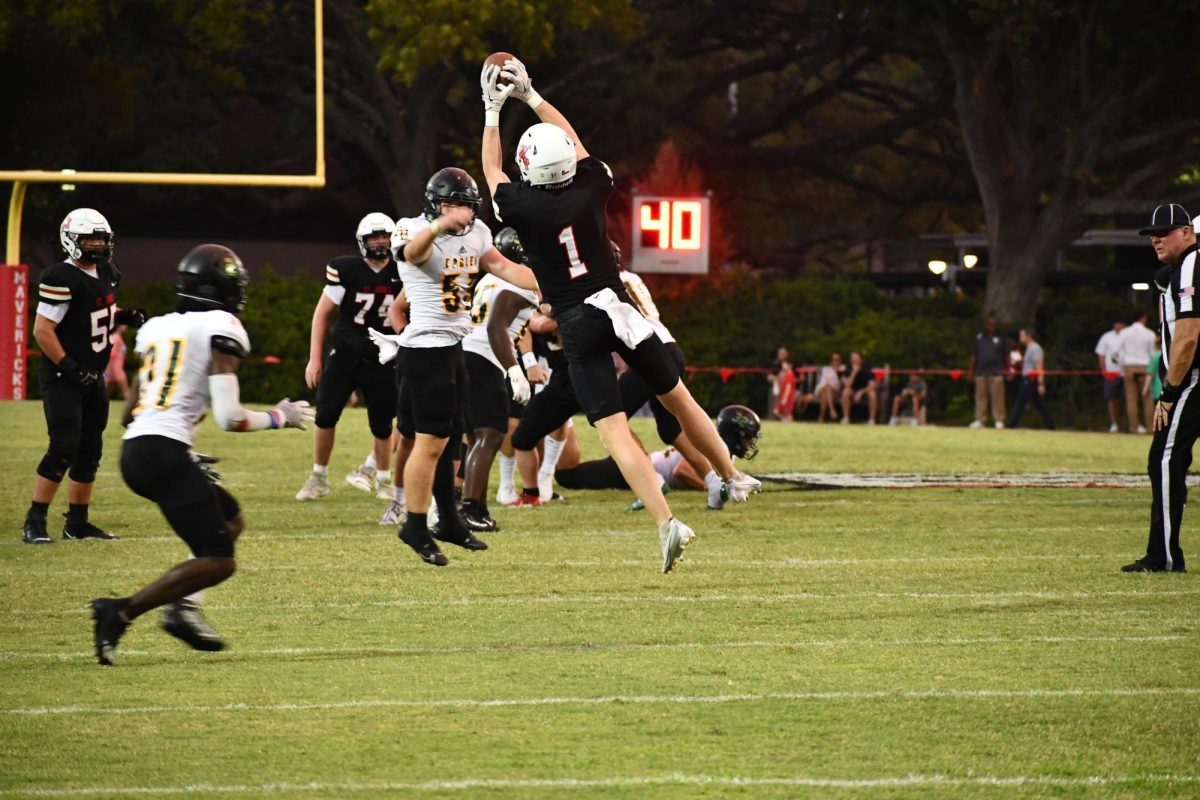 Receiver Logan Donley flies past Eagles linebacker Dequan Murphy to secure a Maverick first down. 