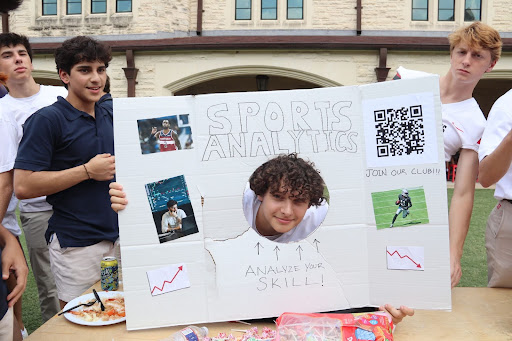 Senior Nico Sturgis pokes his head through the Sports Analytics tri-fold, “scoring” some insights into his skills.