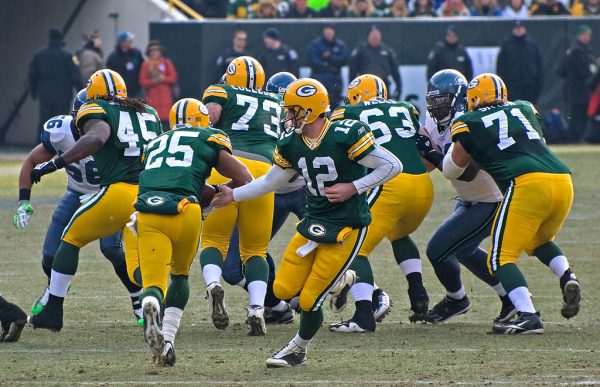Packers quarterback Aaron Rodgers (12) hands off to running back Ryan Grant (25). Rodgers tore his Achilles tendon during a game against the Bills during the 2023 season.