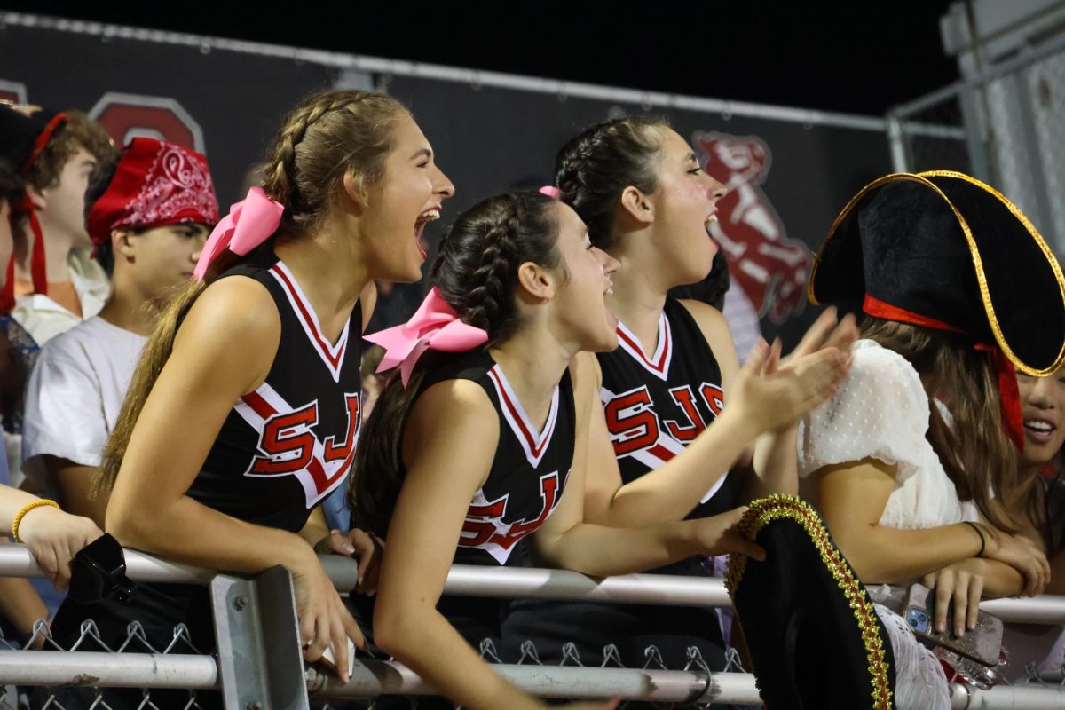 During their third quarter break, seniors Mia Hirshfeld, Ella Piper Claffy and Manning Muller join the fans in the stands on Senior Night against Episcopal School of Dallas.