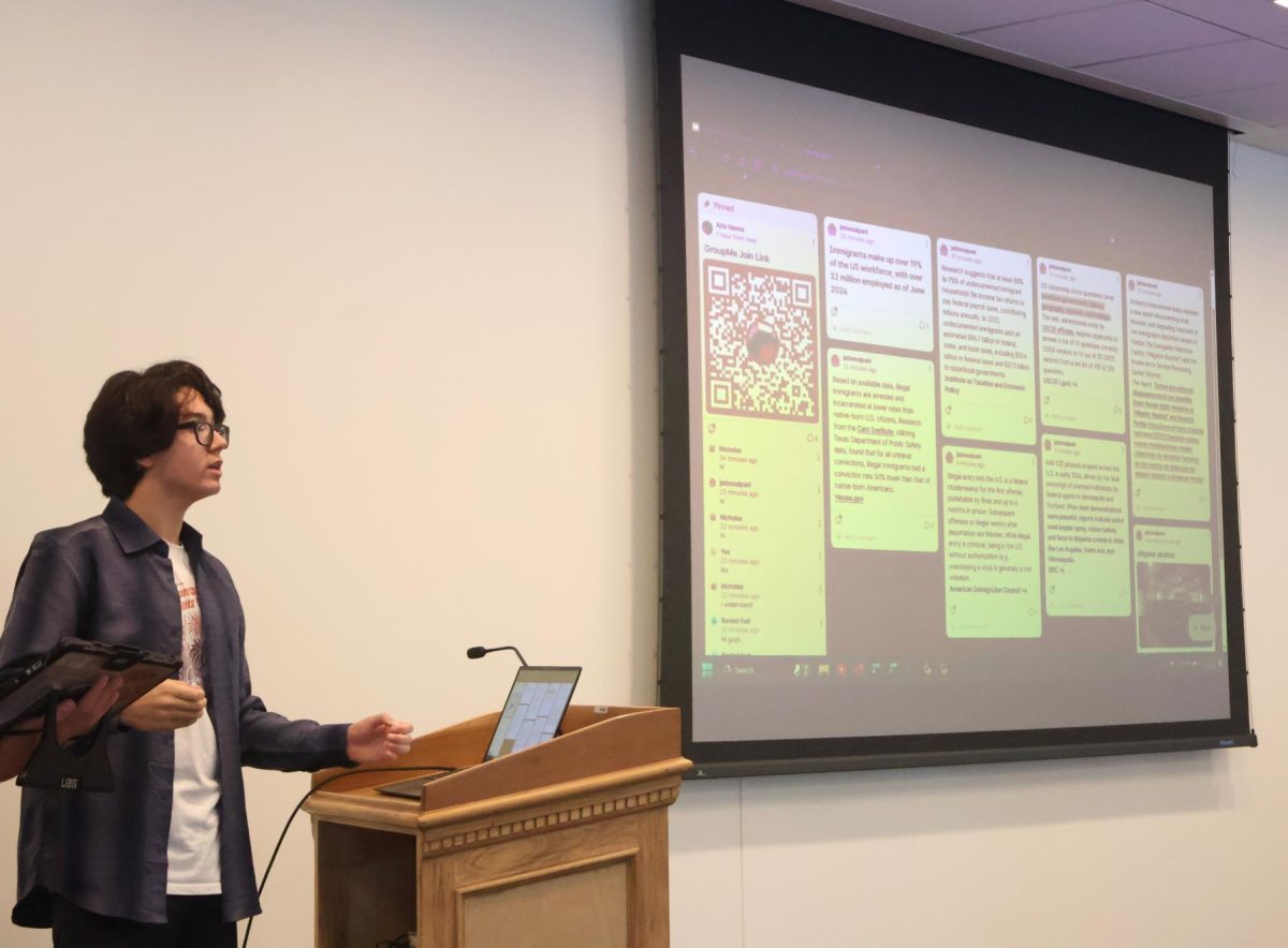 Sophomore Aris Hanna presents at an Open Discourse Education Club meeting.