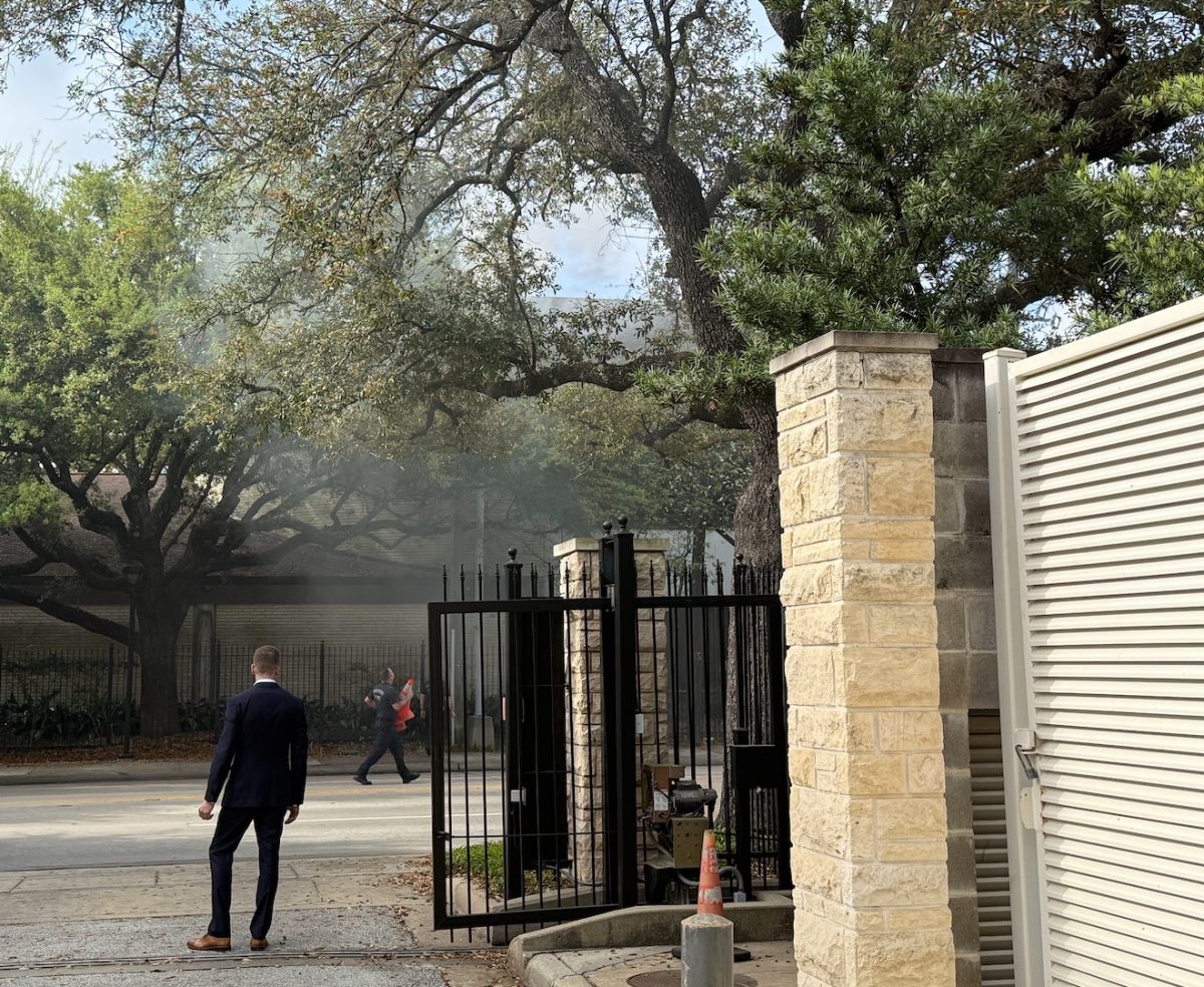 Head of Upper School Dan Alig stands in front of Westheimer while firefighters inspect the smoking transformer.