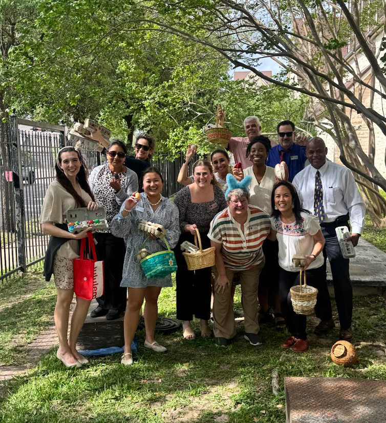 Middle school staff smile with their filled baskets. Math teacher Adrian Pruett won the competition with 56 eggs. 